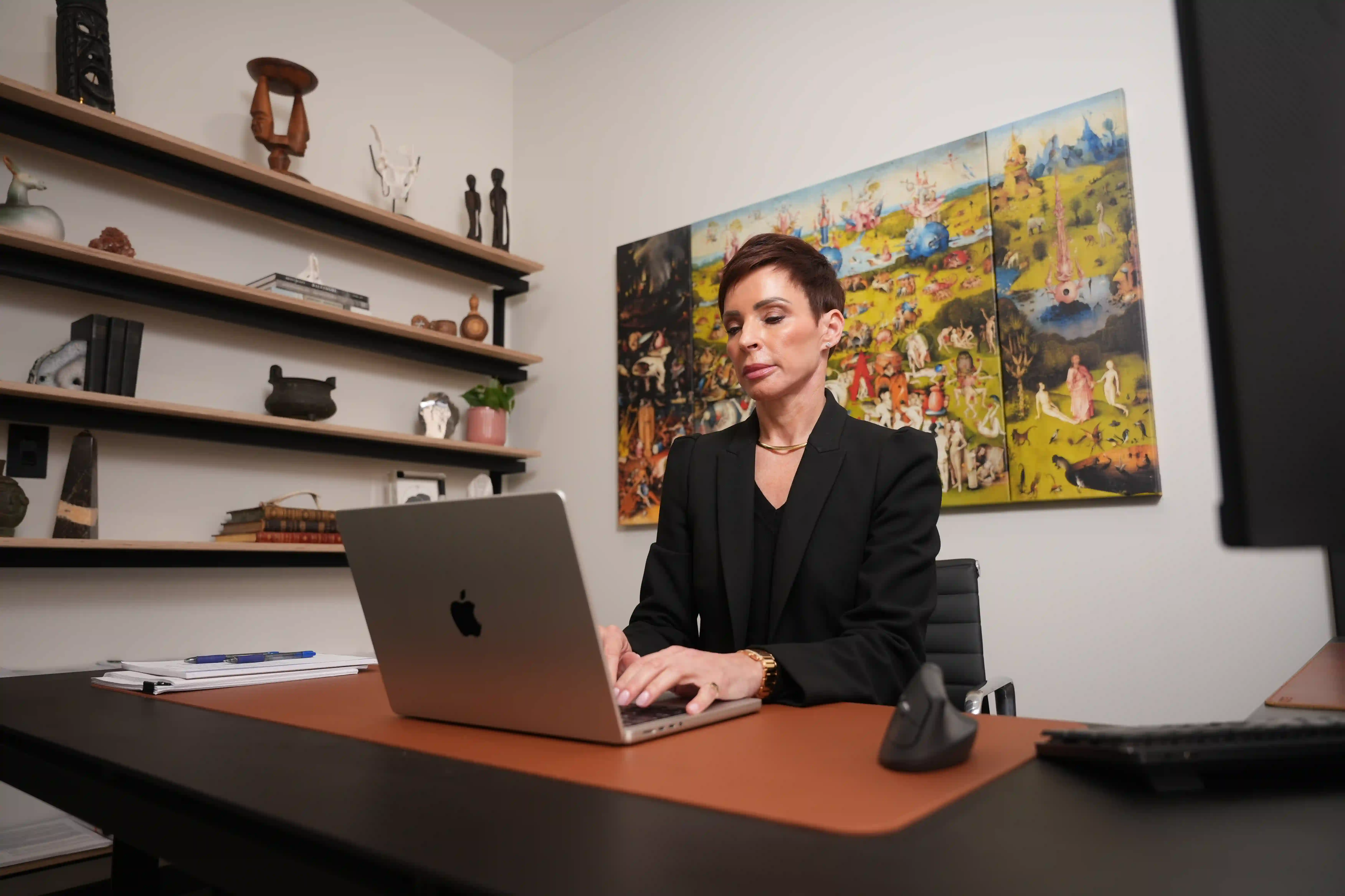 Silvana Raso, Family Law and Matrimonial Attorney at Faugno Weis Duarte Raso, LLC, working on a laptop in Hackensack, NJ