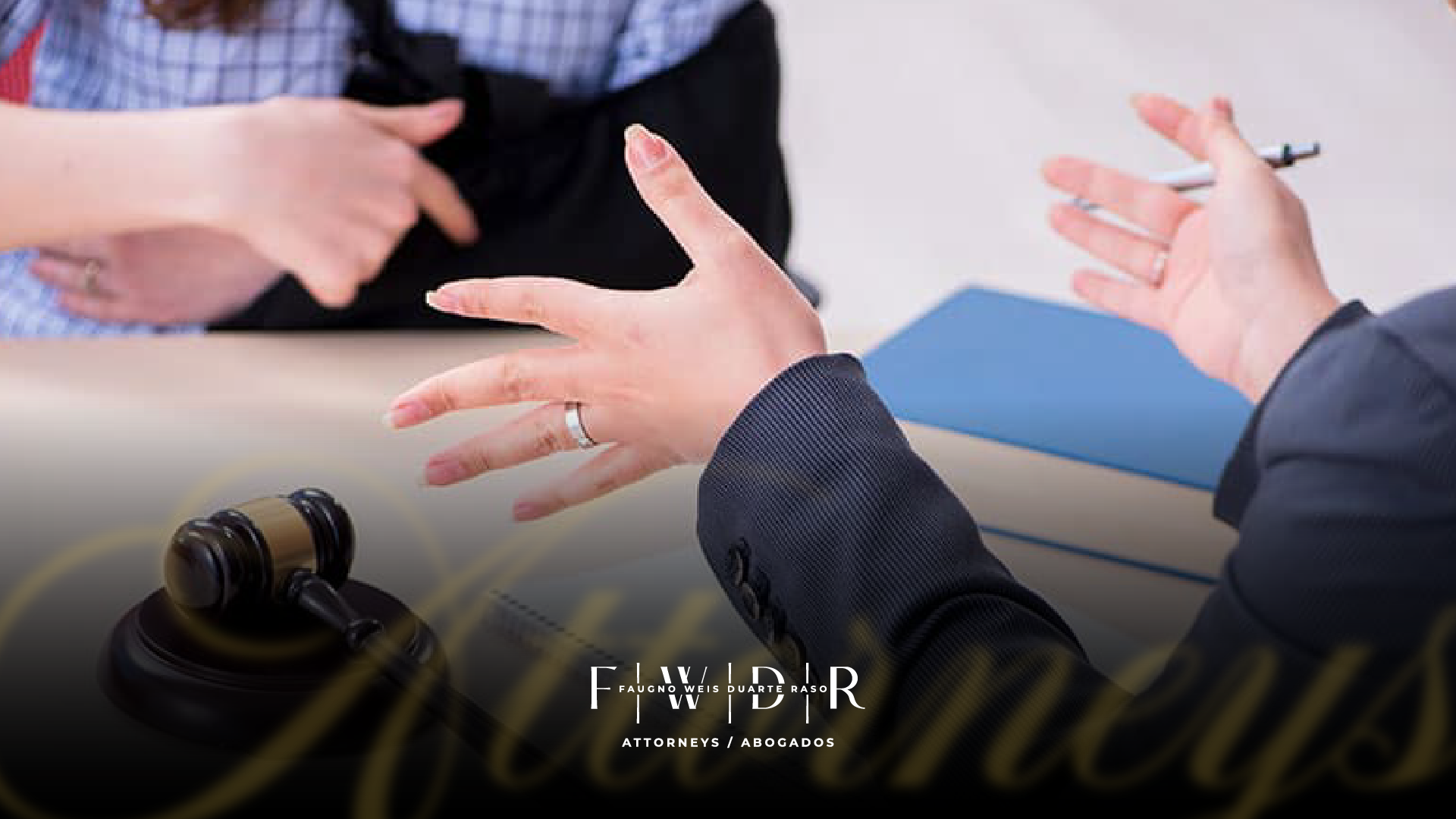 Attorney discussing an insurance claim with a client, gavel in the foreground